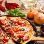 Taking slice of homemade pizza